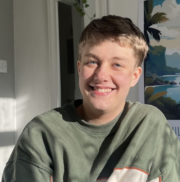 Matthew Kasper, a white man with short fair hair wearing a grey-green sweater.
